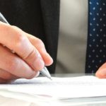 Close up of man's hands signing a contract