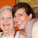 Older woman and younger woman looking at the camera and smiling
