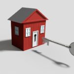 Illustration of a small red house with large silver key in front of it