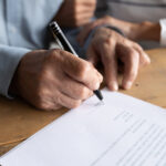 Older man signs legal documents